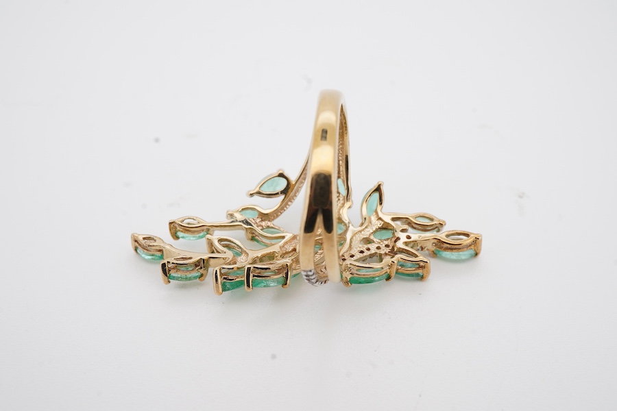 A recent 9ct gold, emerald and diamond set cluster up finger ring, of ornate foliate design, size M/N, gross weight 4.8 grams.